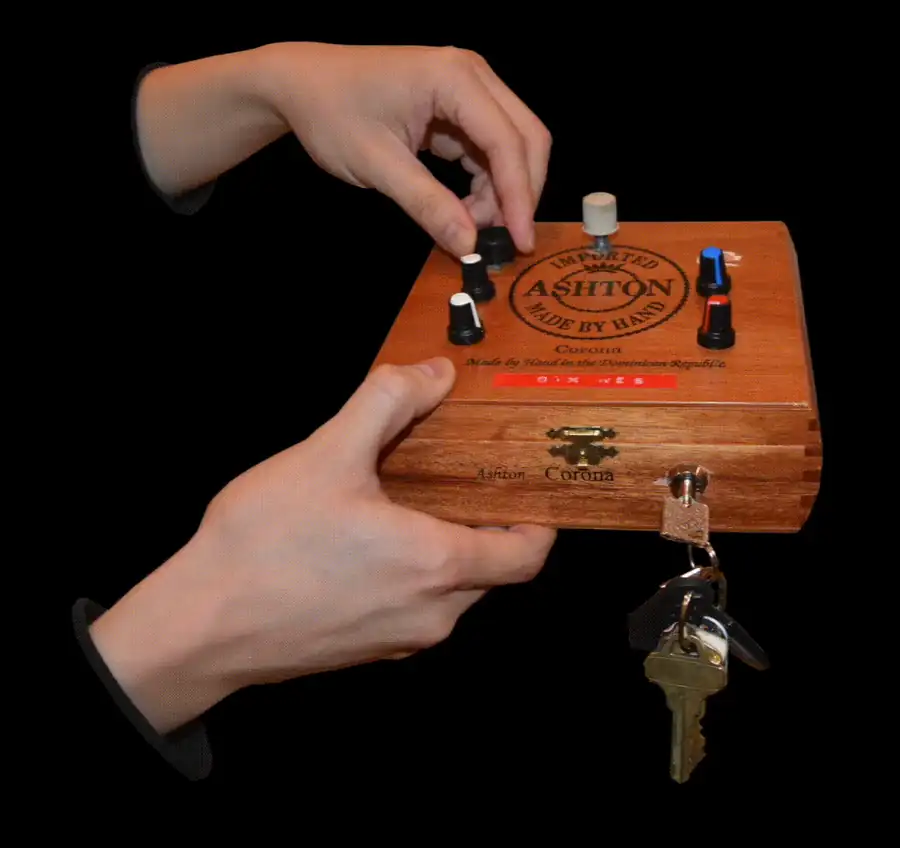 Hands adjusting knobs on a wooden electronic instrument